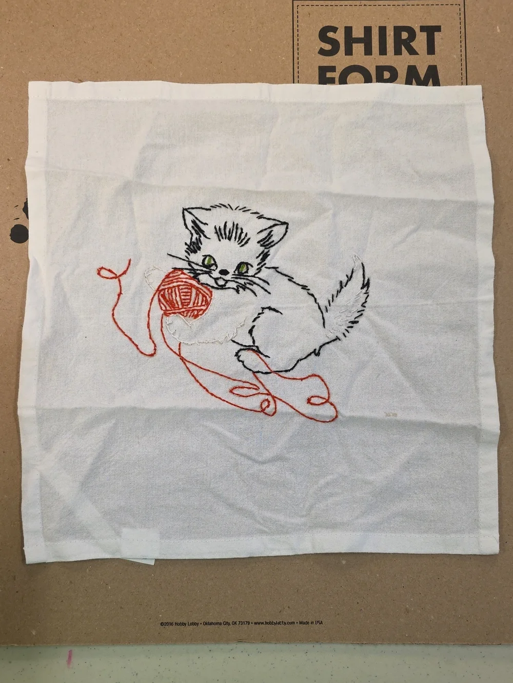White Embroidered Kitten Cloth with Red Yarn Accent